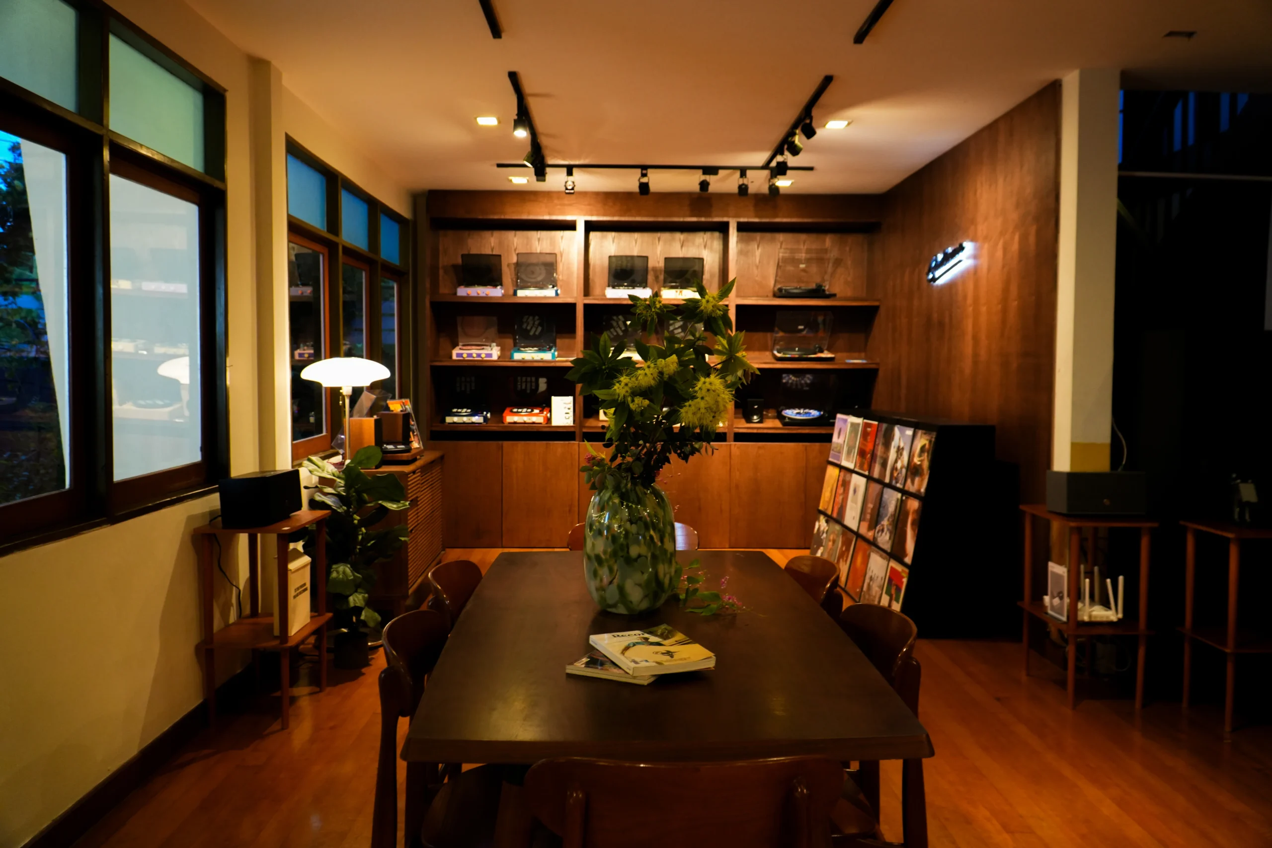 The atmosphere of Gadhouse with a record player and vinyl records displayed on wooden shelves.